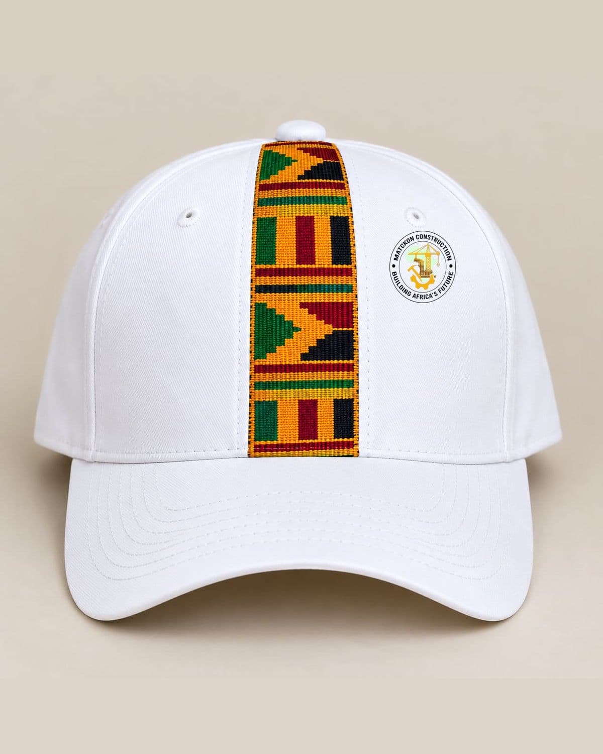 White MATCKON baseball cap with a woven kente panel in green, gold, red and black down the front